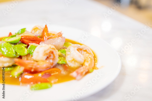 Stir Fried Sator beans with Shrimp on white plate.Thai food. Copy space.