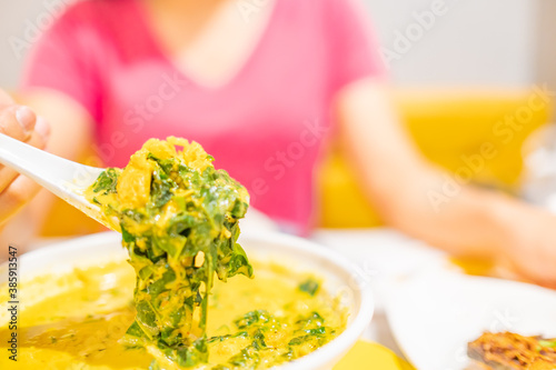 Woman is eating Crab curry with betel leaves. Thailand local food. photo