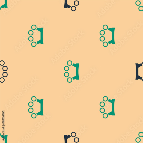 Green and black Brass knuckles icon isolated seamless pattern on beige background. Vector.