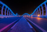 A night view of Meydan Bridge with blue lights