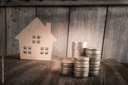 Wood sweet home model and business coin finacial on table