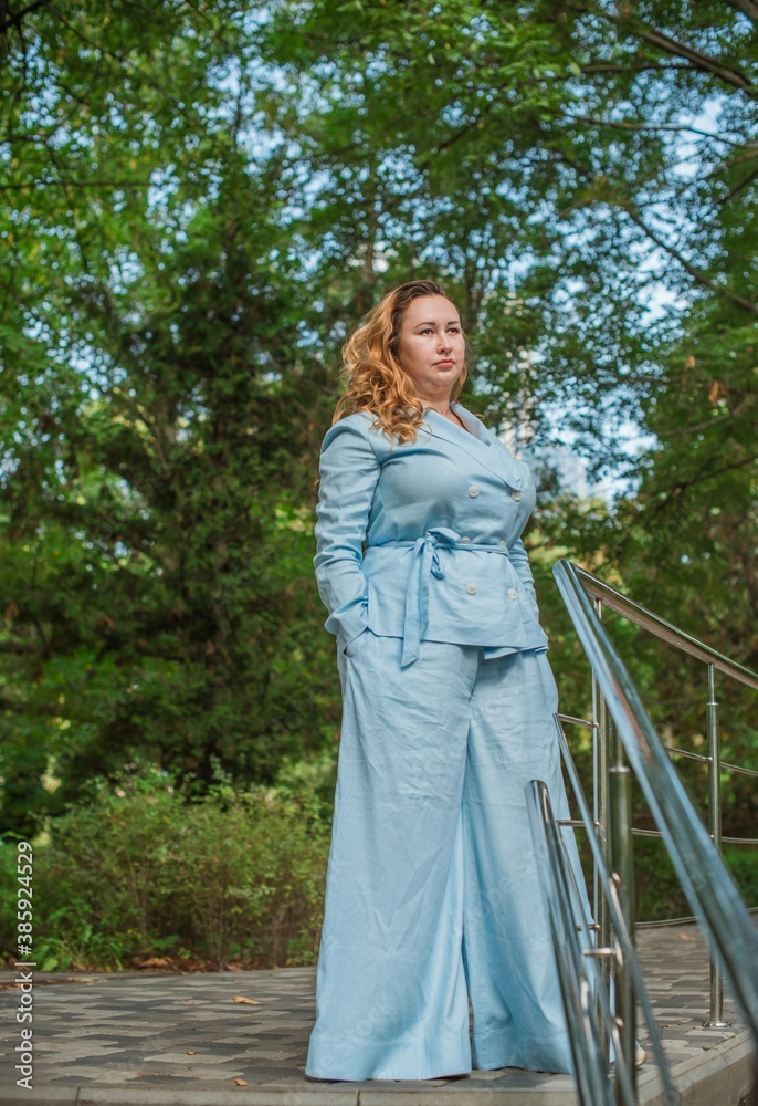 Portrait of American plus size businesswoman in light blue suit, citizen lifestyle, concept of women's life Portrait of American plus size businesswoman in light blue suit, citizen lifestyle, concept of women's life