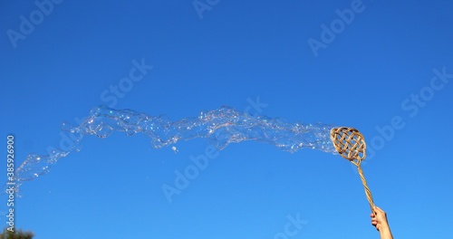 a series of small bubbles created with a carpet beater
against the light and with a beautiful blue sky photo