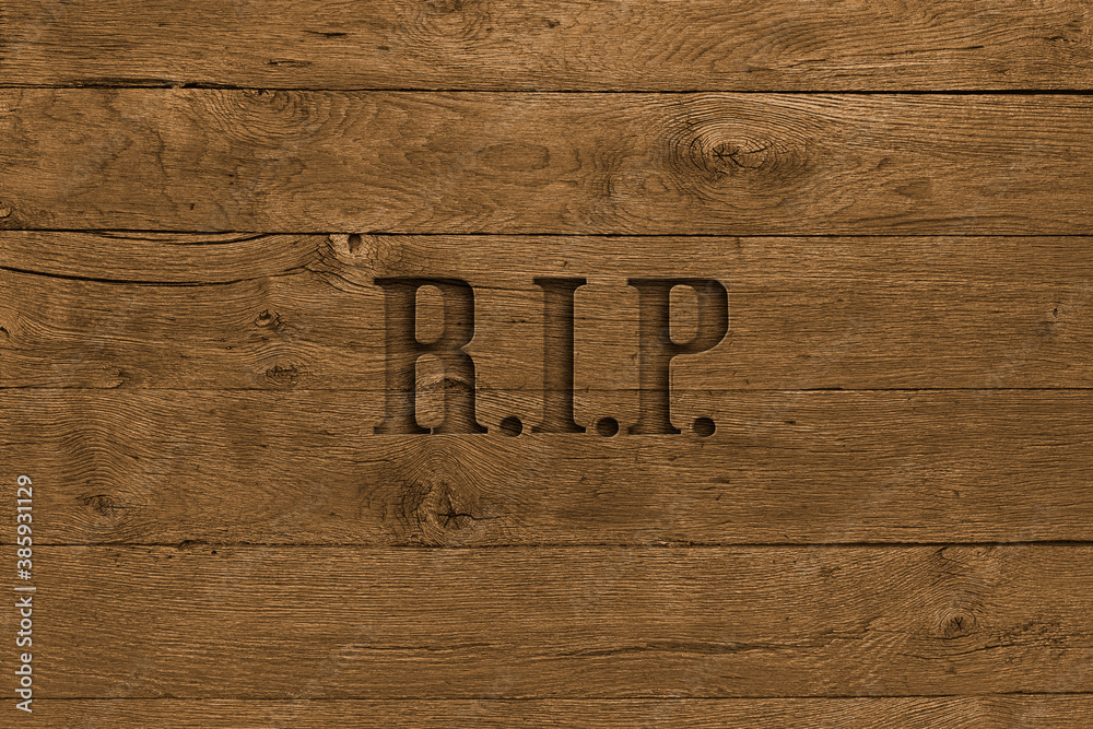 Wooden board with word rip carved in it