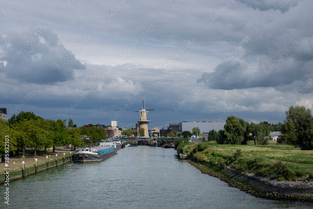 Large stone windmill on a canal in Schiedam, Holland