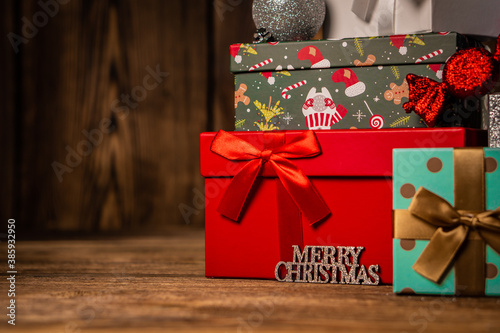 Beautiful Christmas gift boxes presents on wooden background.
