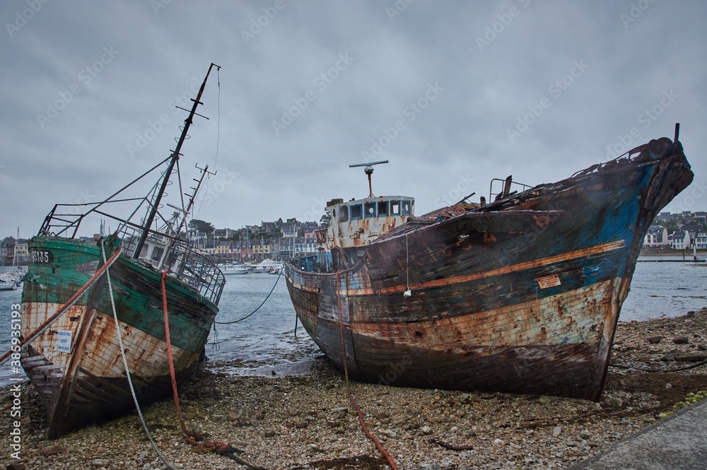 Abandoned shipwrecks in a harbor in Brittany, France.