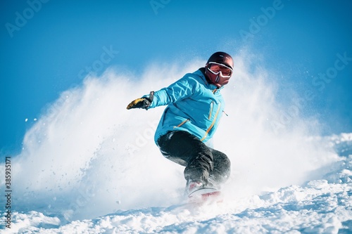 Freeride powder, snowboarding in Les deux alpes resort in winter, mountains in French alps, Rhone Alpes in France. Freeride in helmet on powder snow.