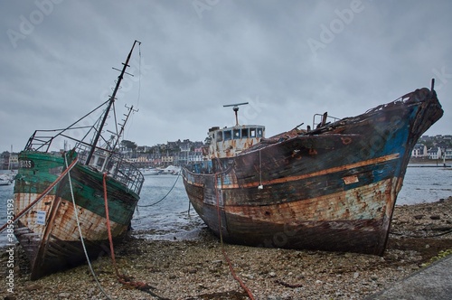 Abandoned shipwrecks in a harbor in Brittany, France.