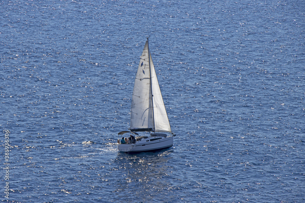 Small Sailing boat yacht in the open blue Sea