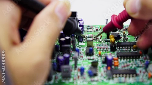 Electronics repair with tester.Repair technician test On an electronic board.Selective focus.	