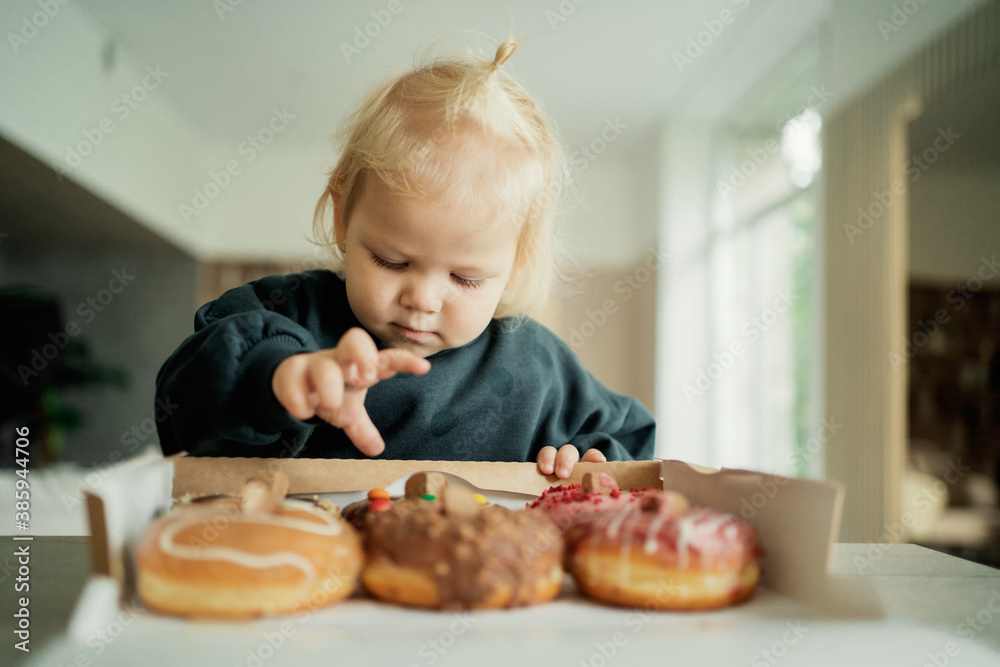 with an appetite, the baby girl eats children for her holiday. Courier fast delivery of food and sweets to your home. the most delicious dessert pastries donuts from the bakery with an appetite, the baby girl eats children for her holiday. Courier fast delivery of food and sweets to your home. the most delicious dessert pastries donuts from the bakery