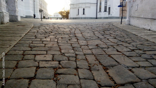 street in the old town. Evening panoramic view of the ancient monastery Pechersk Lavra in Kyiv, Ukraine at sunset