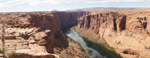 Glen Canyon Dam with steep sandstone cliffs into Colorado River near Lake Powell in Arizona, USA.