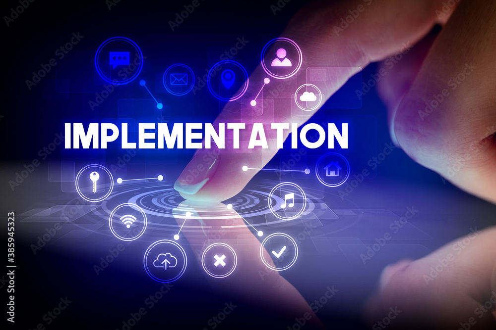Finger touching tablet with web technology icons and IMPLEMENTATION inscription, web technology concept