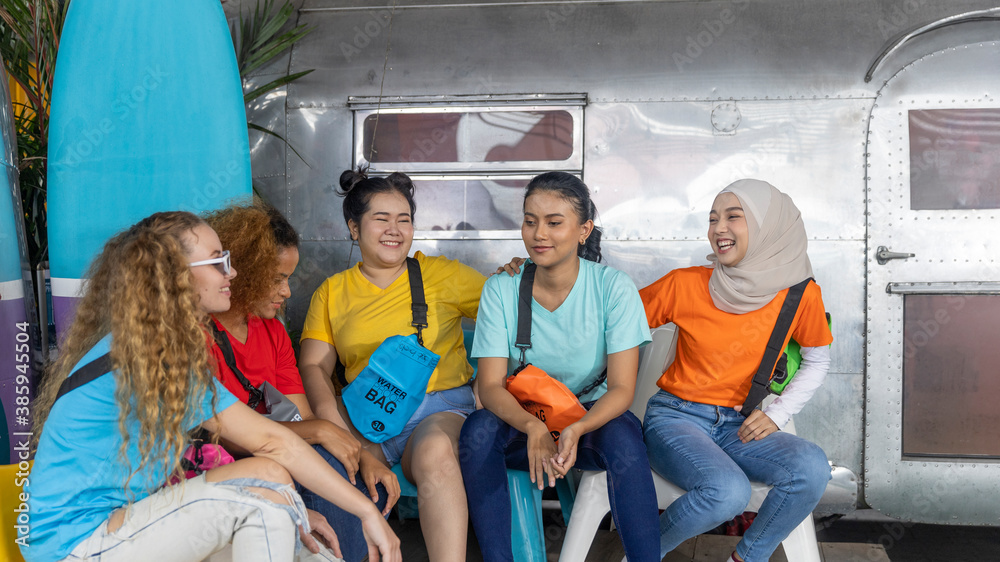Young working women from different ethnic groups or races enjoy camping on a holiday. Friendship across cultures during vacation