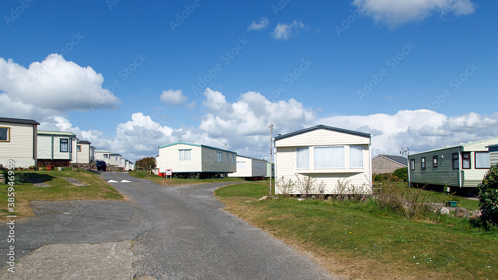 Caravan Park - static caravans in Gower with a panoramic format and a blue sky background. Caravan Park - static caravans in Gower with a panoramic format and a blue sky background.
