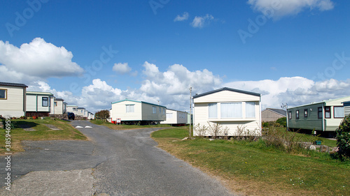 Caravan Park - static caravans in Gower with a panoramic format and a blue sky background. © Jackie Davies