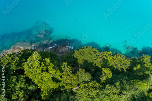 Drone aerial view shot of Tropical sea with green trees beautiful seashore island in Phuket Thailand.