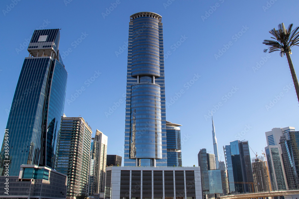 Skyscrapers of Business bay district of Dubai, UAE. Burj Khalifa, the tallest building in the world can be seen in the picture.