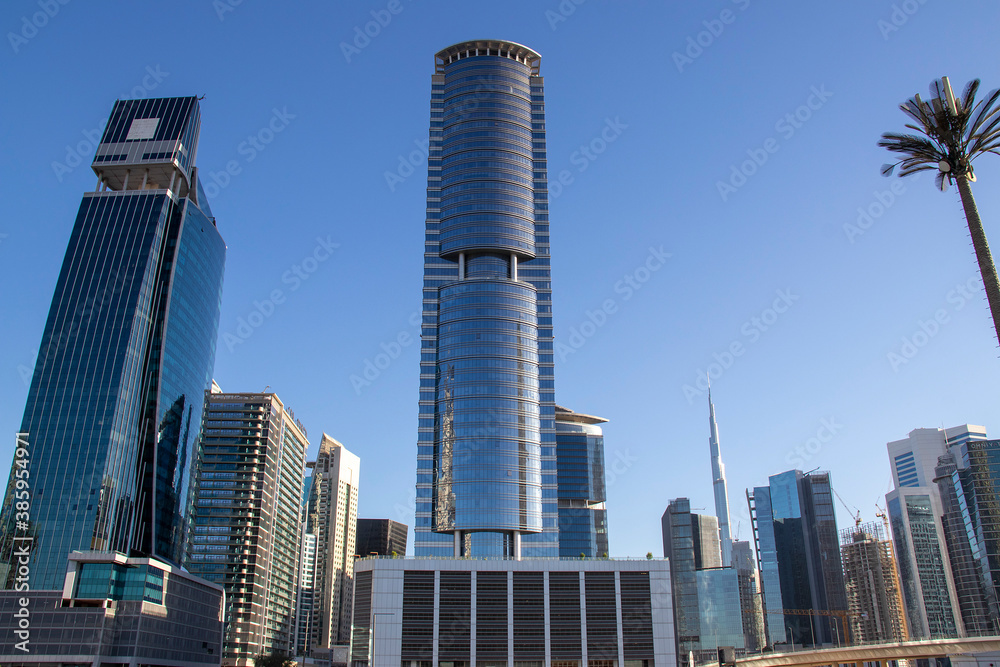 Skyscrapers of Business bay district of Dubai, UAE. Burj Khalifa, the tallest building in the world can be seen in the picture. Skyscrapers of Business bay district of Dubai, UAE. Burj Khalifa, the tallest building in the world can be seen in the picture.