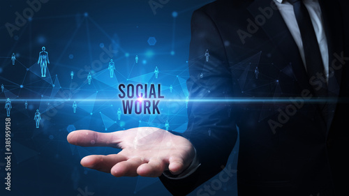 Elegant hand holding SOCIAL WORK inscription, social networking concept