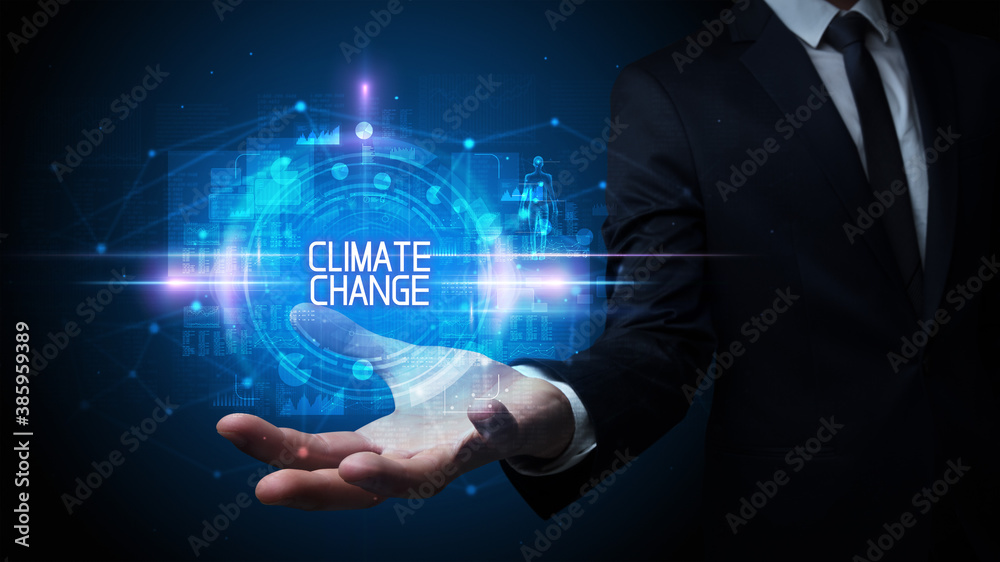 Man hand holding CLIMATE CHANGE inscription, technology concept