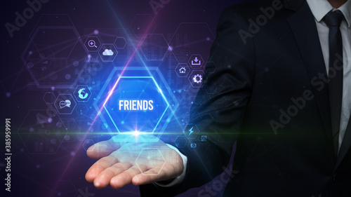 Wallpaper Mural Man hand holding FRIENDS inscription, social media concept Torontodigital.ca