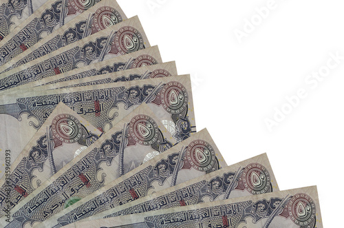 50 UAE dirhams bills lies isolated on white background with copy space stacked in fan close up photo