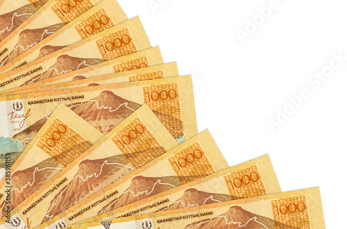 1000 Kazakhstani tenge bills lies isolated on white background with copy space stacked in fan close up photo