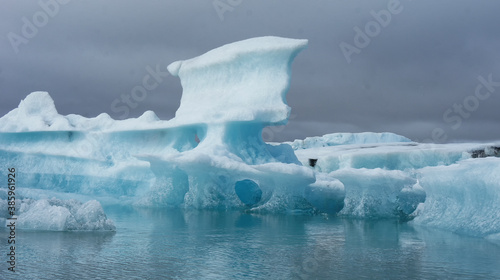 Floating ice berg with unique shapes in Iceland on overcast day
