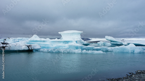 Floating ice berg with unique shapes in Iceland on overcast day