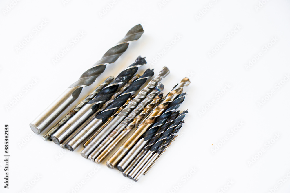 Stainless steel cordless drill heads on the white background Stainless steel cordless drill heads on the white background