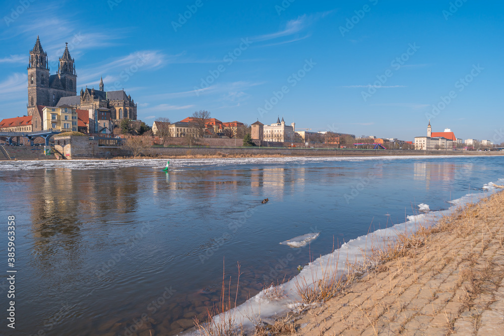 Magdeburg downtown in Winter with ice drift in Elbe river, Germany, sunny day.