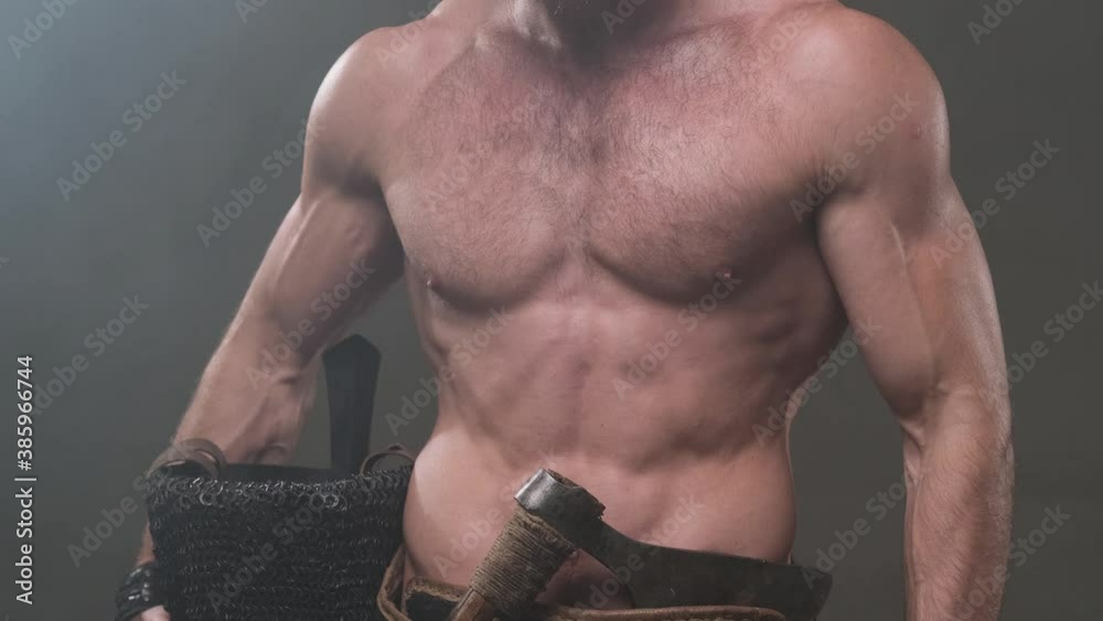 Stockvideo Camera shoots moving up from below showing muscular and