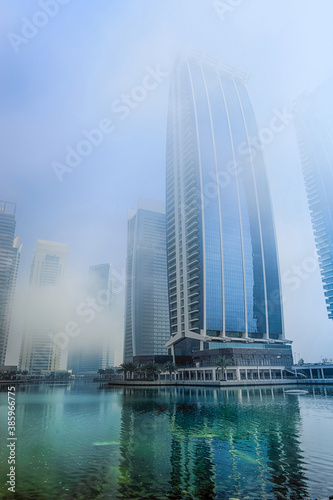 A beautiful winter weather in Dubai. Stock image. A foggy morning at a modern skyline in Dubai. photo