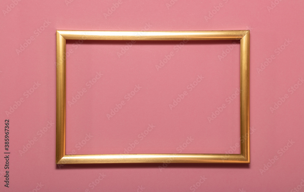 Golden empty frame picture on pink background . Copy space for text. Holiday card concept. Mock up. Greeting. Mother's Day. St Valentine's Day. Love and devotion concepts. Golden empty frame picture on pink background . Copy space for text. Holiday card concept. Mock up. Greeting. Mother's Day. St Valentine's Day. Love and devotion concepts.