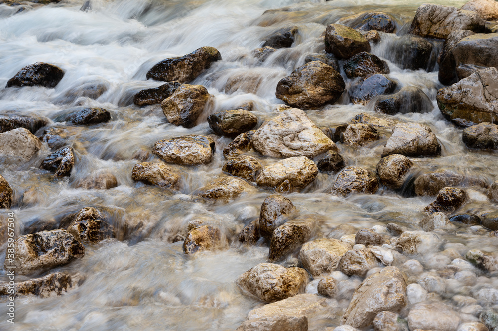 Mountain cold river flowing among stones