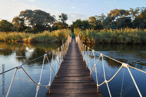 Fototapeta Naklejka Na Ścianę i Meble -  Wooden bridge over the Okavango river