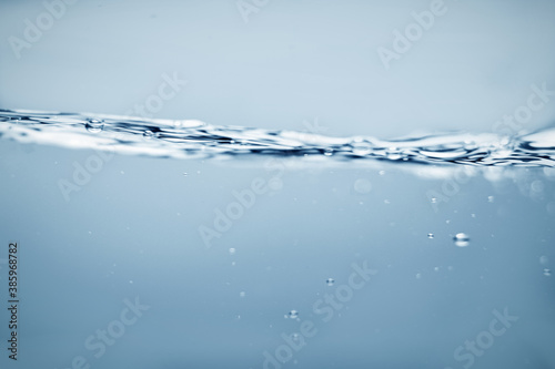 Water wave surface with bubbles of air. Side view of Water