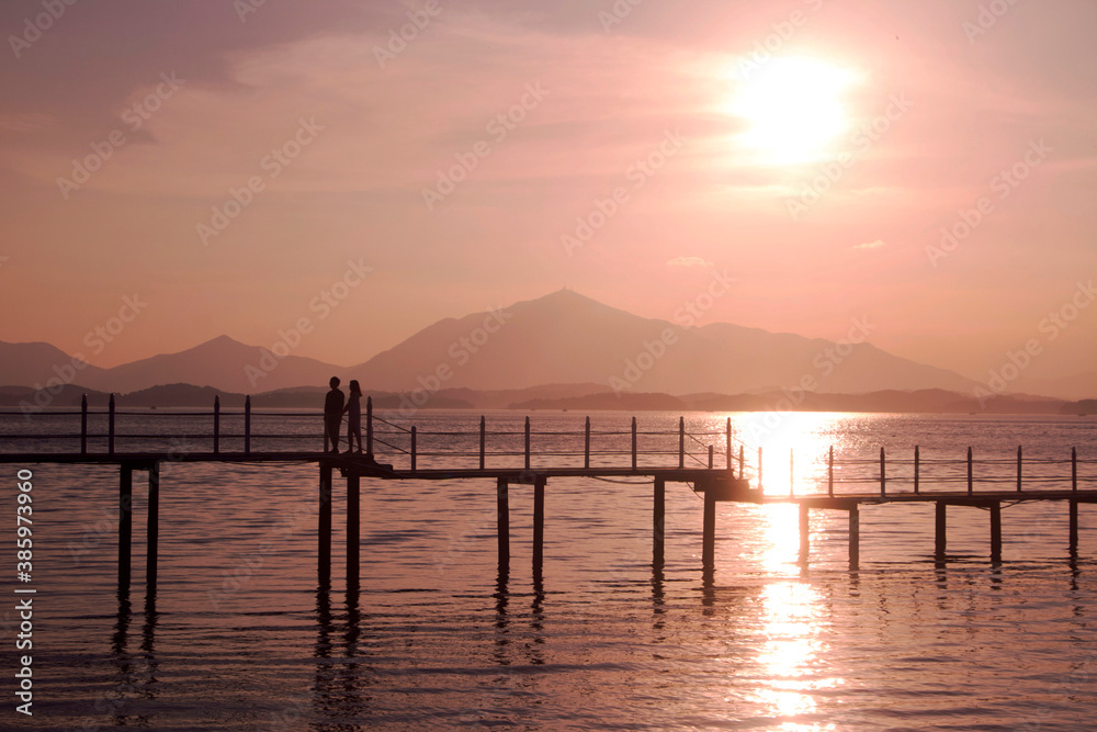 Beautiful sunset with Wooden bridge over the sea in sacheon city, Korea
