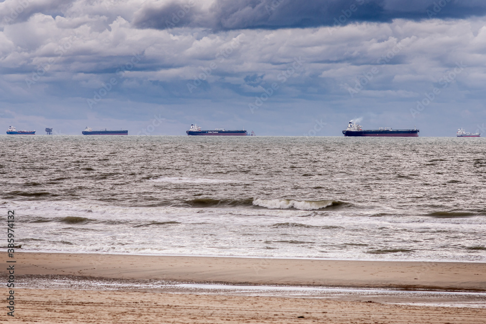 Dunes on the Katwijk beach, Netherlands, with cruisers and tankers on the horizon Dunes on the Katwijk beach, Netherlands, with cruisers and tankers on the horizon