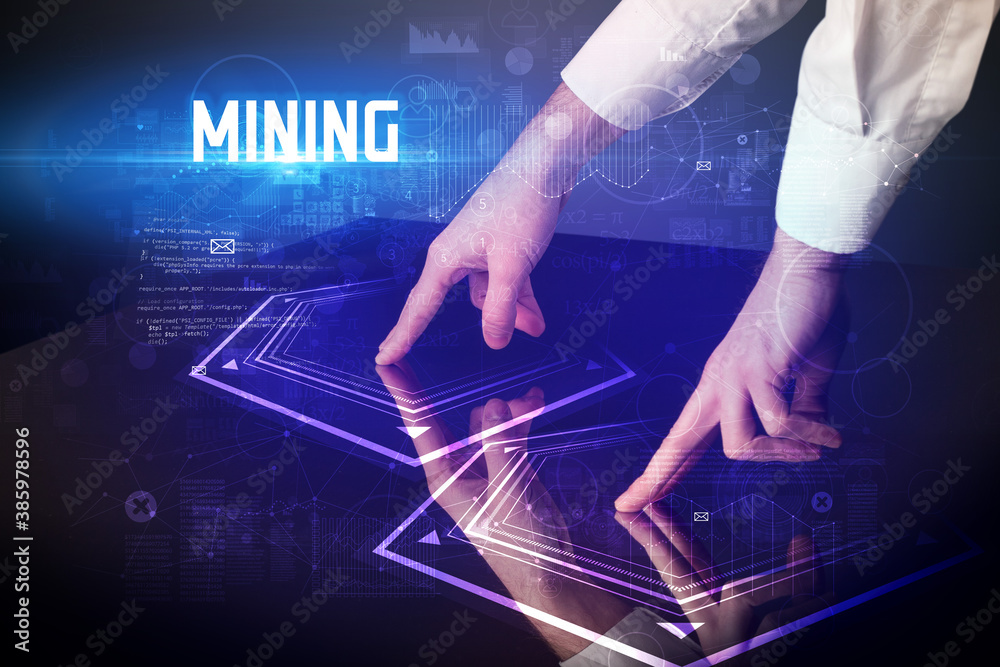 Hand touching digital table with MINING inscription, new age security concept Hand touching digital table with MINING inscription, new age security concept