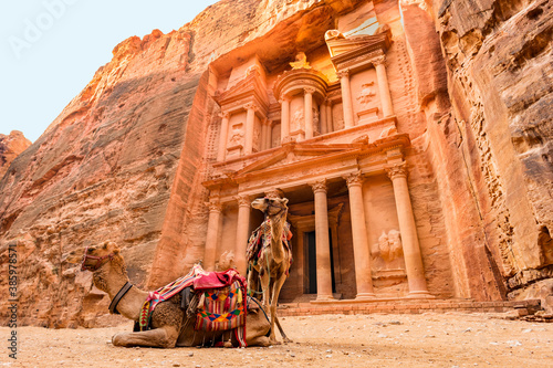 Stunning view of two camels posing in front of the Al Khazneh (The Treasury) in Petra. Al-Khazneh is one of the most elaborate temples in Petra, Jordan. photo