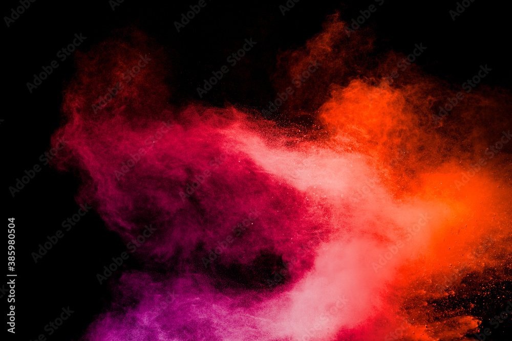 Red pink color powder explosion on black background.Freeze motion of red dust particles splashing.