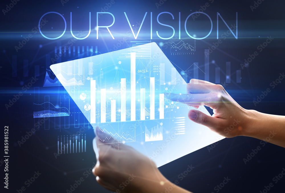 Hand holding futuristic tablet with OUR VISION inscription above, modern business concept Hand holding futuristic tablet with OUR VISION inscription above, modern business concept
