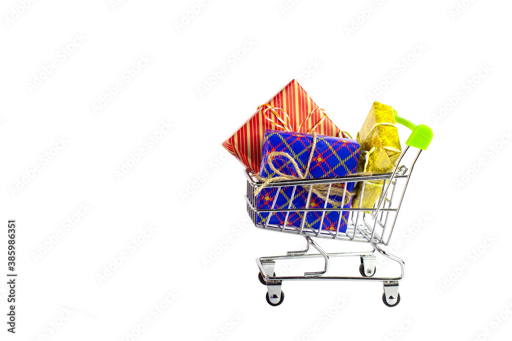 Boxes with gifts in bright packaging and shopping cart, preparation for the holidays, shopping. Boxes with gifts in bright packaging and shopping cart, preparation for the holidays, shopping.