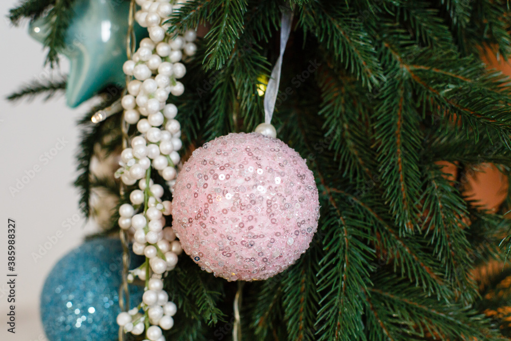 Christmas tree background. New Year composition with spruce, balls and lights. beautiful decorative pink ball on the spruce. Traditional Christmas toys with beautiful ornament Christmas tree background. New Year composition with spruce, balls and lights. beautiful decorative pink ball on the spruce. Traditional Christmas toys with beautiful ornament
