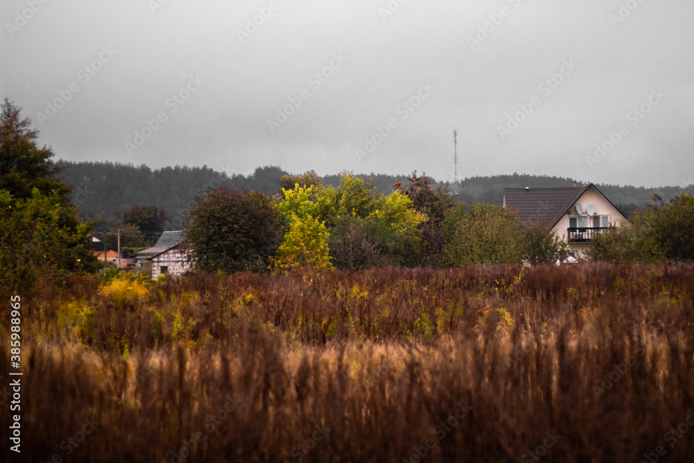 Beautiful autumn moody landscape - fields and houses of village shrouded in mist in the morning. Beautiful autumn moody landscape - fields and houses of village shrouded in mist in the morning.