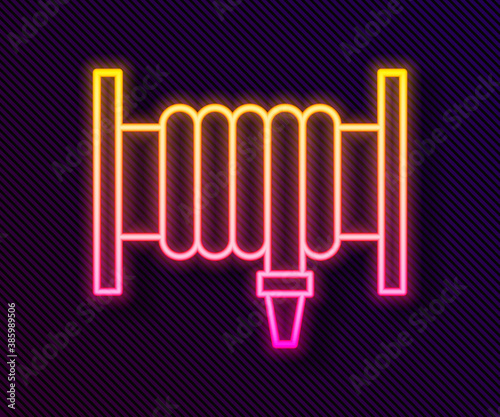 Glowing neon line Fire hose reel icon isolated on black background. Vector.